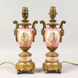 A PAIR OF FRENCH SEVRES STYLE PORCELAIN AND GILT METAL LAMPS, painted with reverse panels of