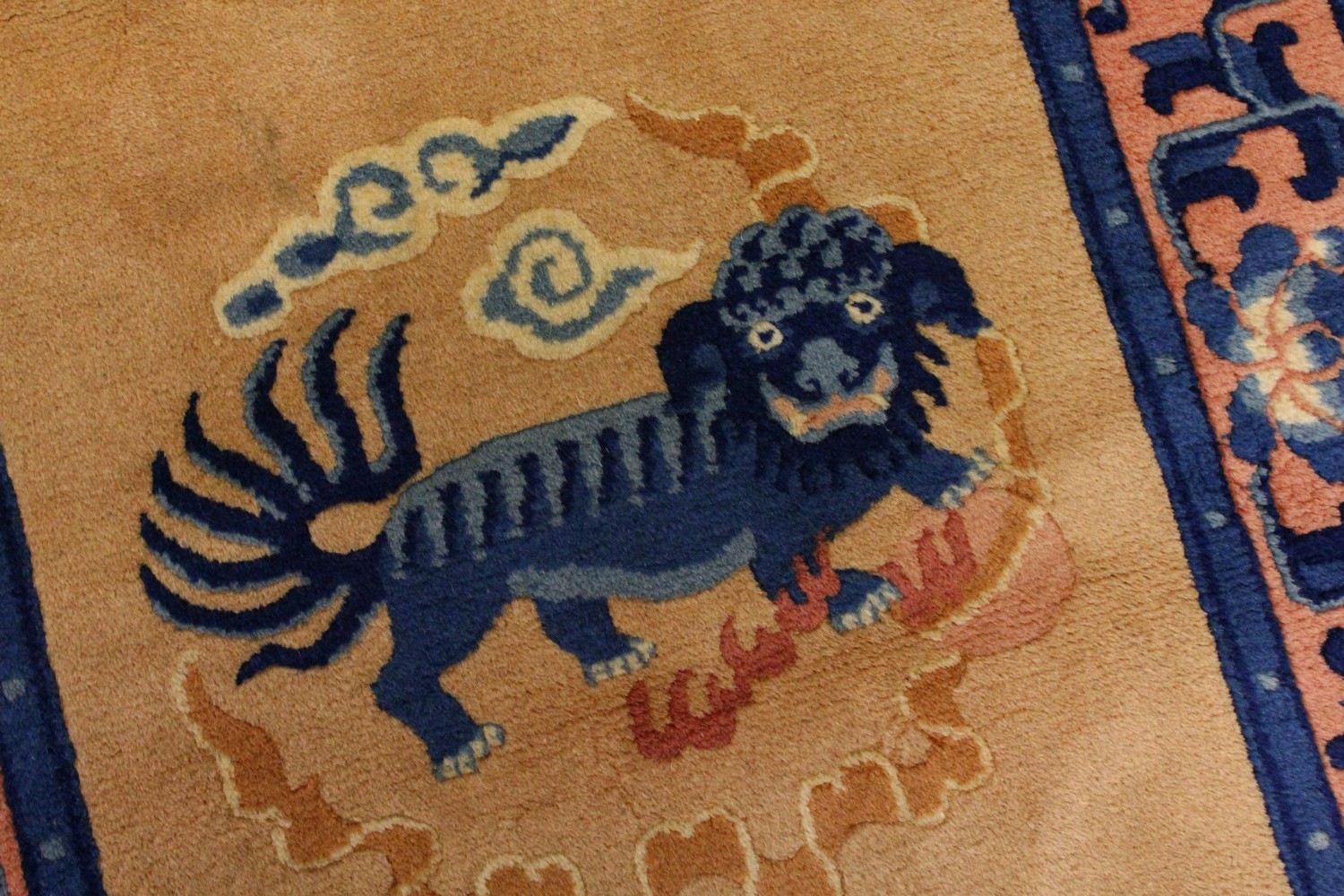 A CHINESE RUG, the centre with Dog of Fo motifs, beige ground and blue border. 5ft x 2ft 5ins.`` - Image 2 of 6