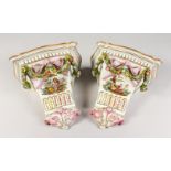 A GOOD PAIR OF MEISSEN DESIGN PORCELAIN BRACKETS, painted with figures with applied garlands. 9ins.