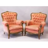 A PAIR OF FRENCH STYLE BUTTON UPHOLSTERED ARMCHAIRS, 20TH CENTURY, with carved giltwood frames, on