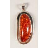 A SILVER AND AMBER PENDANT.