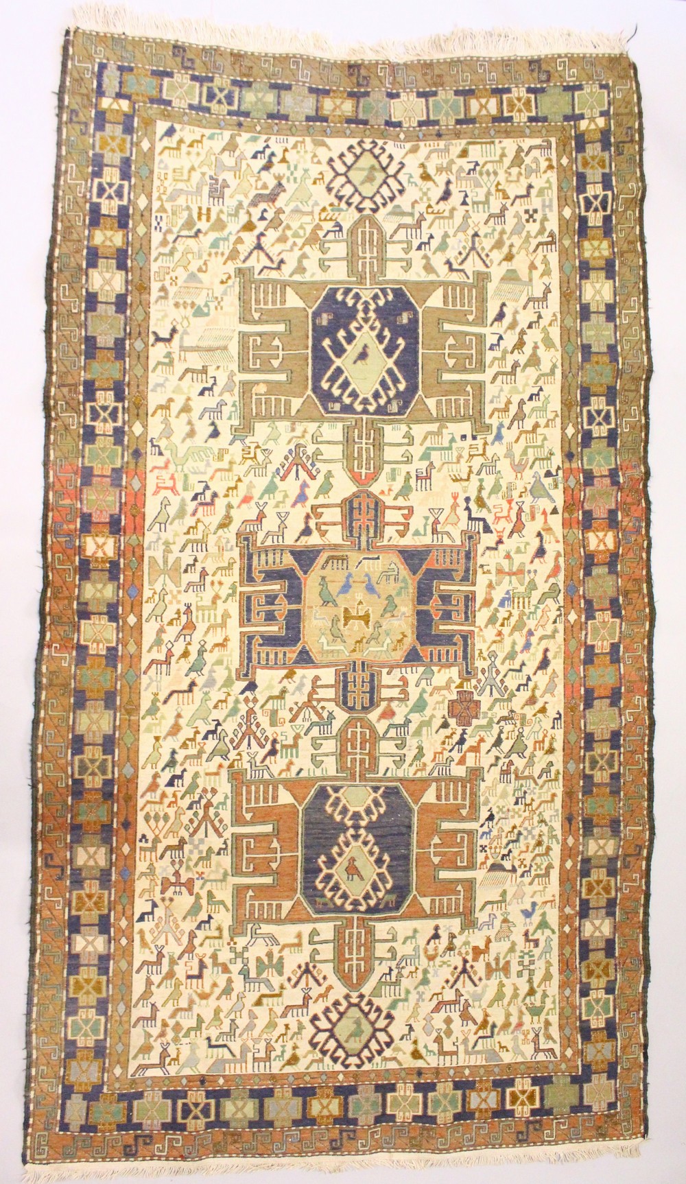 AN EASTERN TRIBAL RUG, cream ground with stylised bird motifs. 6ft 8ins x 3ft 9ins.