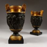 A PAIR OF FRENCH NEO CLASSICAL BRONZE AND ORMOLU URNS, relief cast with classical figures, on square