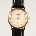 A GENTLEMAN'S LONGINES GOLD WRISTWATCH, with leather strap, in original box.