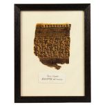 A SMALL EGYPTIAN COPTIC FRAGMENT, framed and glazed. 13ins x 10ins.