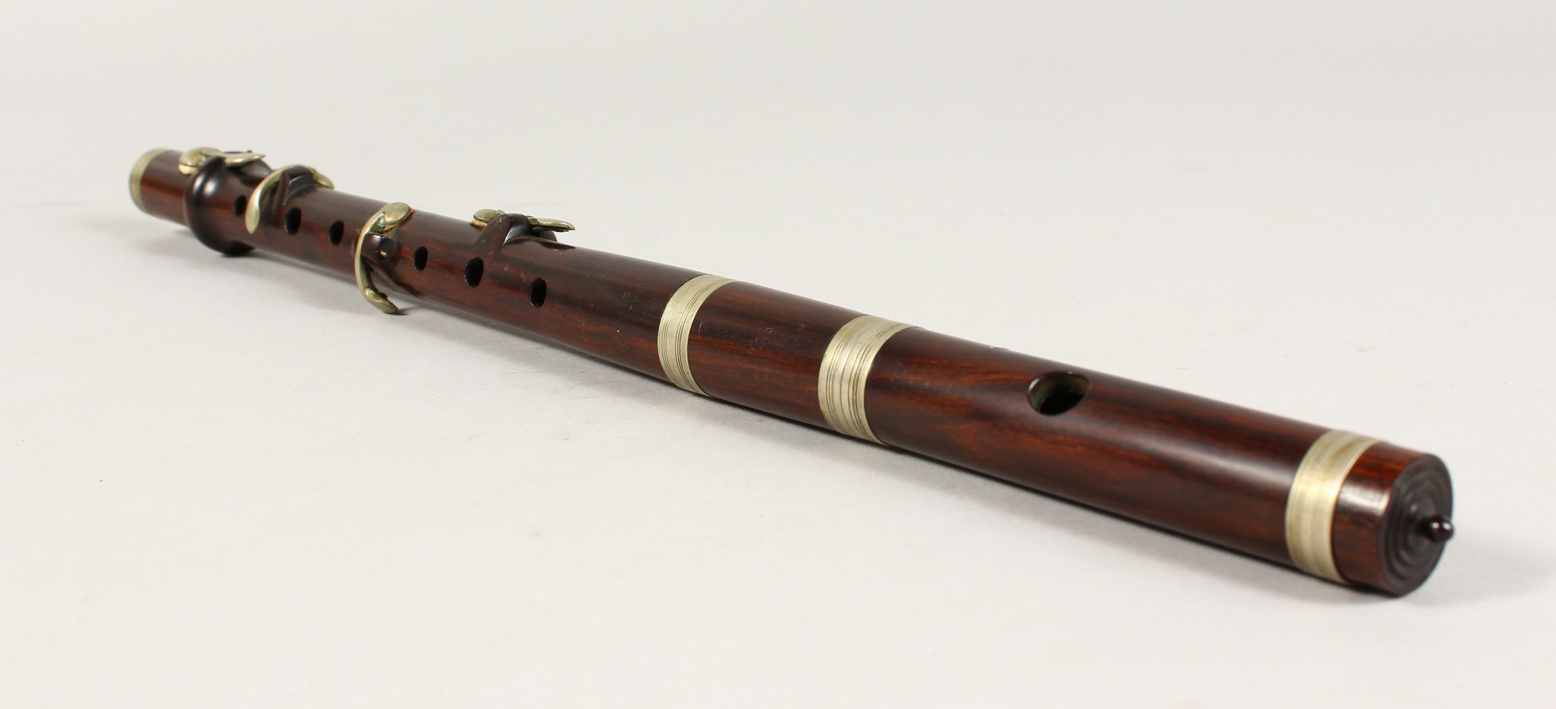 A ROSEWOOD MUSICAL INSTRUMENT. 15.5ins long.