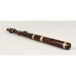 A ROSEWOOD MUSICAL INSTRUMENT. 15.5ins long.