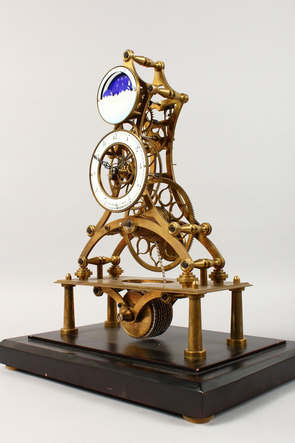 A MOON PHASE SKELETON CLOCK in a glass case. 17.5ins high including case. - Image 2 of 10