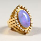 A VERY GOOD 18CT GOLD, FIRE OPAL AND DIAMOND RING.