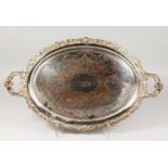 A VICTORIAN OVAL ENGRAVED TWO-HANDLED TEA TRAY. 27ins long.