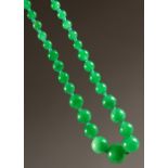 A STRING OF JADE BEADS.