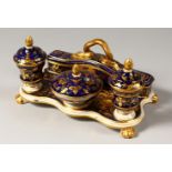 A CROWN DERBY BLUE AND GILT TABLE INKSTAND, on claw feet. Mark in Red. 8ins long.