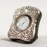 A SILVER CASED QUARTZ CLOCK. 3.5ins high.