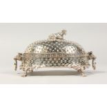 A PIERCED PLATED OVAL BUTTER DISH, with cow handle and glass liner.