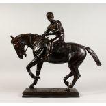 A SUPERB LARGE BRONZE HORSE AND JOCKEY, the jockey holding the reins, the horses left foot up, on