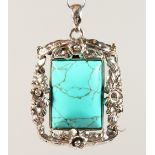 A SILVER AND TURQUOISE PENDANT.