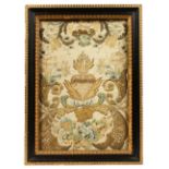 A 19TH CENTURY SILK AND METAL THREAD EMBROIDERED PICTURE, with a crucifix, heart shape emblem and