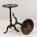 TWO CHINOISERIE DECORATED BLACK LACQUER TRIPOD TABLES. 1ft 8ins high x 1ft 0ins diameter.