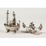 A SILVER SEESAW and FISHING BOAT.