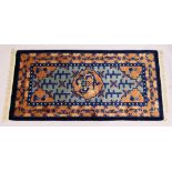 A CHINESE RUG, with central motif and blue motifs. 5ft x 2ft 3ins.