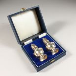 A PAIR OF BALUSTER SHAPED PEPPERETTES, boxed. Birmingham 1988. Maker: B. Ltd. 4ins high.