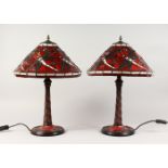 A PAIR OF TIFFANY STYLE RED GLASS DRAGONFLY TABLE LAMPS. 22ins high.