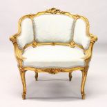 A 19TH CENTURY FRENCH GILTWOOD FAUTEUIL, with carved decoration, upholstered with a pale blue