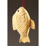 A CHINESE CARVED BONE FISH LOOP PENDANT. 3.5ins.