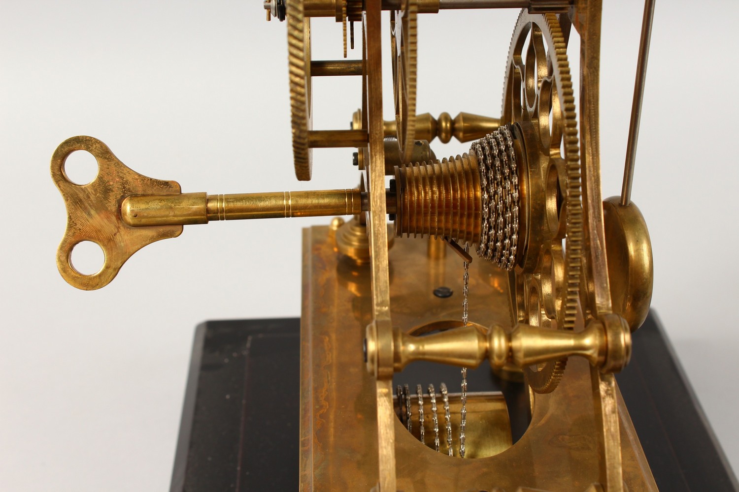 A MOON PHASE SKELETON CLOCK in a glass case. 17.5ins high including case. - Image 7 of 10