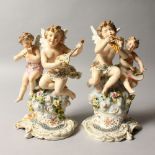 A PAIR OF CONTINENTAL PORCELAIN GROUP OF CUPIDS, playing musical instruments. 7.5ins high.