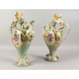A GOOD PAIR OF SEVRES DESIGN PORCELAIN EWERS AND COVERS, painted with flowers with cupid mounts.