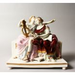 A CONTINENTAL PORCELAIN GROUP OF TWO CLASSICAL YOUNG LADIES, one holding a lyre and sitting on a