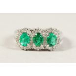 A GOOD 18CT WHITE GOLD FIVE STONE EMERALD AND DIAMOND RING.