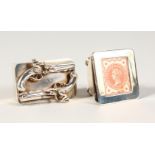 A SILVER SNUFF BOX, the lid with two pistols, and A STAMP BOX (2).