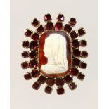 A GOOD GEORGIAN HARDSTONE CAMEO, with garnet surround.