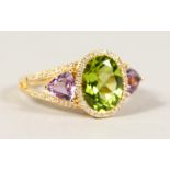 AN 18CT GOLD, PERIDOT AND AMETHYST RING.
