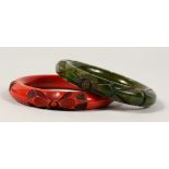 TWO CHINESE RED AND GREEN LACQUER BRACELETS.