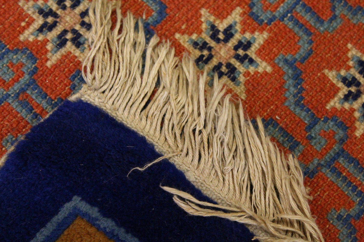 A CHINESE RUG, with red ground, motifs and blue border. 4ft 9ins x 2ft 4ins. - Image 5 of 5