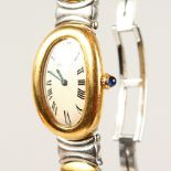 A VERY GOOD LADIES CARTIER STEEL AND GOLD OVAL FACED WRISTWATCH, No. 4196, in original red box.