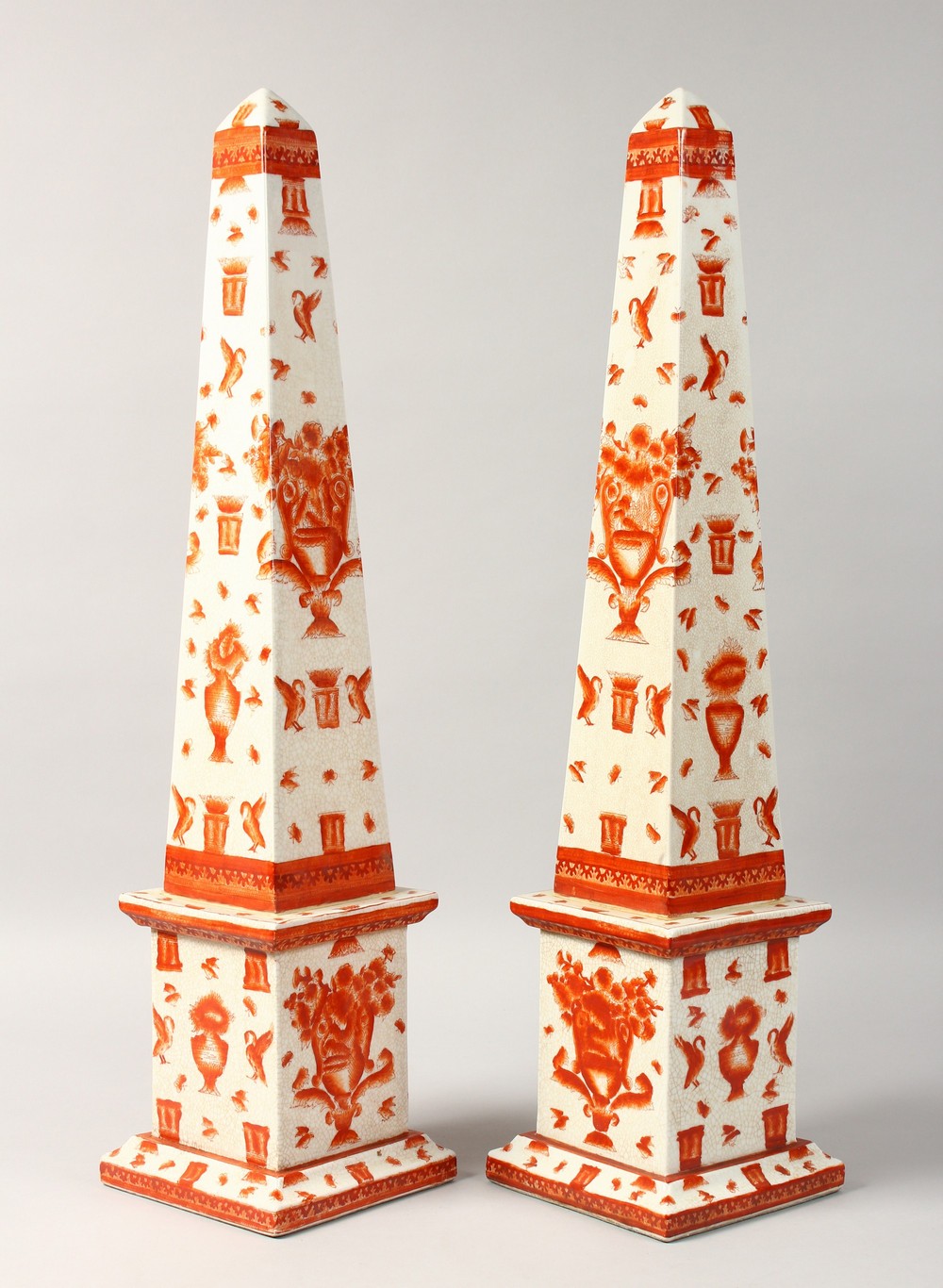 A LARGE PAIR OF OBELISKS with birds and motifs. 25ins high.