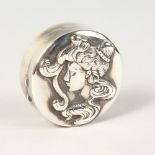 A SILVER CIRCULAR BOX, the lid as a head of a lady.