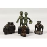A SMALL AFRICAN BRONZE GROUP, two figures standing side by side; together with three small carved