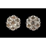 A PAIR OF 18CT GOLD DIAMOND CLUSTER EAR STUDS.