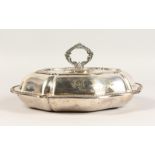 AN ENTREE DISH AND COVER, with engraved crest. 12.5ins wide.