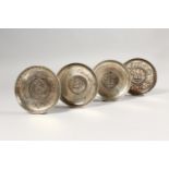 A SET OF FOUR CHINESE CIRCULAR DISHES, inset with coins. 9.5cms diameter.