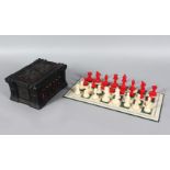 A STAUNTON RED AND WHITE IVORY CHESS SET, King 7cms high, and GOTHIC design box, Circa. 1860.