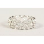 AN 18CT WHITE GOLD DIAMOND HEART SHAPED ETERNITY RING of 60 points.