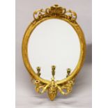 A 19TH CENTURY GILTWOOD GIRANDOLE, with shell cresting, oval mirror plate, three scrolling candle