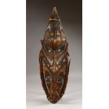 A NEW GUINEA SEPIK RIVER CARVED AND PAINTED SHIELD SHAPE MASK. 25ins high.