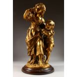 A LARGE GILDED SPELTER GROUP, a young girl and boy gathering the harvest, on a wood base. 22ins